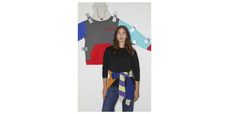 mmERCH_Hoodie_taped_to_wall